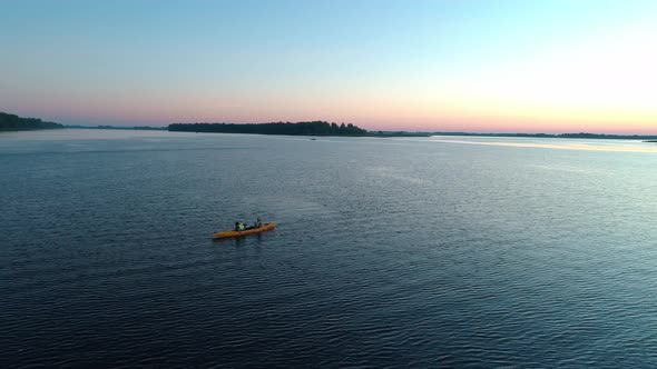 Aerial Drone Footage. Tourists Are Kayaking. Beautiful Sunrise Over River