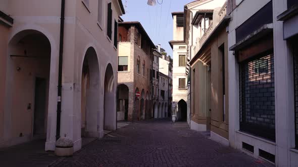 Old and New City Buildings with Arches Surround Street Road