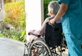 Caregiver help and care Asian senior woman patient sitting in wheelchair on ramp at hospital. - PhotoDune Item for Sale