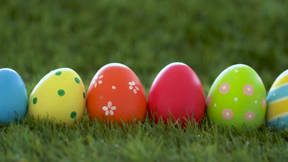 Row of Colored Easter Eggs on Artificial Grass