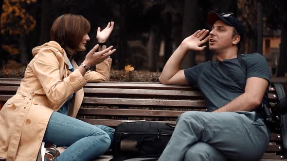 Couple are Sitting in the Park and Talking