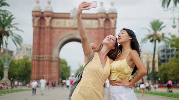 Smiling Mixedrace Females Taking Selfie or Shooting Blog While Having Fun Outdoors in Summertime