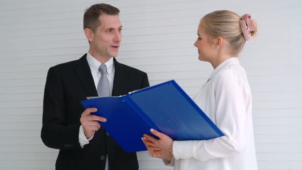 Two Business People Talk Project Strategy at Office