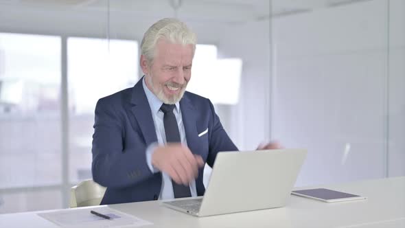 Old Businessman Celebrating Success on Laptop