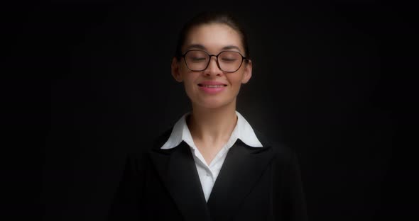 Asian Woman in Glasses Smiling and Shows Five Fingers with Her Right Hand