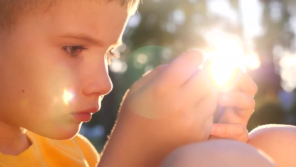 Young Gamer Playing Game on Mobile. Kid with Smartphone Smartphone. Children and Technology. Online