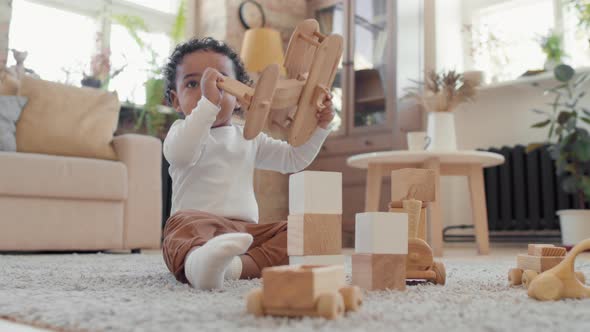 Adorable Baby Boy Playing with Wooden Toy