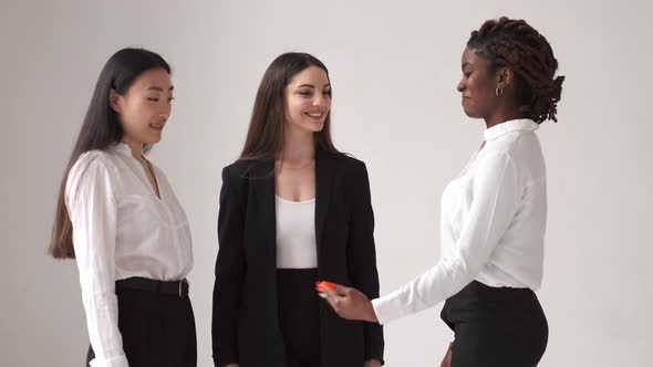 Three Diverse Women Talking on White Background