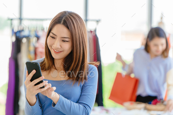 Smart customer using mobile phone to finding promotion search sale item payment in shopping store