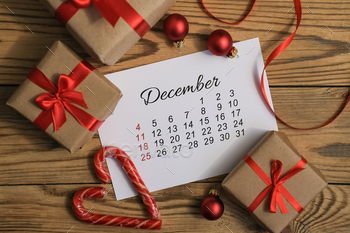 Page december calendar with Christmas gift boxes and decoration around. Xmas preparation