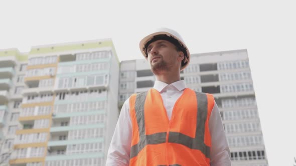 The foreman leaves the construction site after a hard day and goes home.