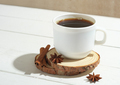 espresso coffee in white mug on wooden table with cinnamin sticks and anise stars. - PhotoDune Item for Sale