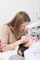young beautician woman making false lash procedure for a client. lash extension procedure - PhotoDune Item for Sale