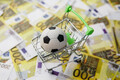 Soccer ball in shopping cart on euro banknotes background. Football cup earnings. - PhotoDune Item for Sale