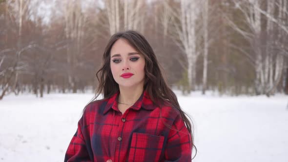 Charming Female with Long Hair Walking in Snowy Forest