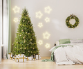 Christmas three with ornaments, festive lights and white and golden gift boxes in room near bed - PhotoDune Item for Sale