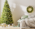 Christmas three with ornaments, festive lights and white and golden gift boxes in room near bed - PhotoDune Item for Sale