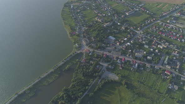 Aerial of a city and a lake alt