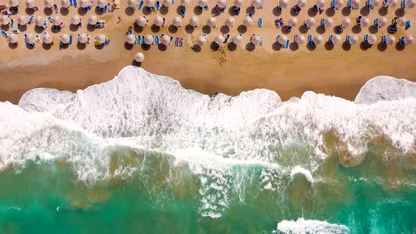 Aerial View of the Sea Sandy Beach Sun Umbrellas and Sunbeds Unrecognizable People