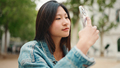 Beautiful Asian woman looking inspired taking photos of beautiful city on smartphone - PhotoDune Item for Sale