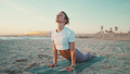 Beautiful woman exercising on yoga mat outdoors. Fitness girl in sportswear practicing yoga on beach - PhotoDune Item for Sale