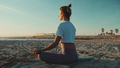 Back view beautiful woman in sportswear sitting in lotus pose meditating by the sea - PhotoDune Item for Sale