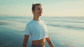Attractive woman looking happy breathing fresh air during walk along the sea after yoga practice - PhotoDune Item for Sale