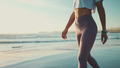 Beautiful woman body walking along the sea. Sporty girl with slim body enjoying morning on beach - PhotoDune Item for Sale