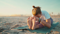 Yoga teacher exercising on mat stretching body during morning yoga at beach - PhotoDune Item for Sale