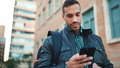 andsome man standing on street with backpack searching hotel to stay using smartphone outdoors - PhotoDune Item for Sale