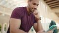 Close up muscular man dressed casual checking his social media using smartphone outdoors - PhotoDune Item for Sale