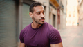 Handsome muscular man looking confident while walking down the narrow street - PhotoDune Item for Sale