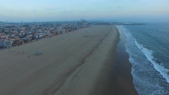 Aerial shot of waves breaking on the beach.