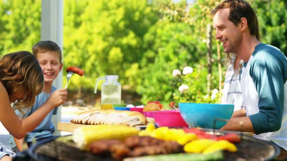 Grilling meat and vegetables on barbecue