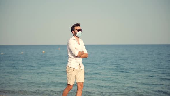 Sad Man In Face Mask At Covid Looking On Sea New Normal. Lockdown On Vacation. City Lockdown.