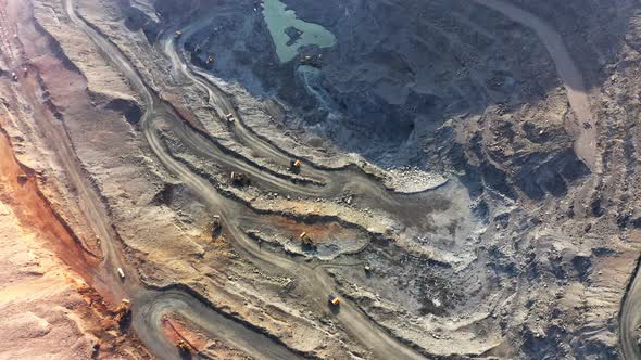 Huge Belaz Trucks Driving on the Pit Bottom in Mining Factory Mine Quarry in Ukraine