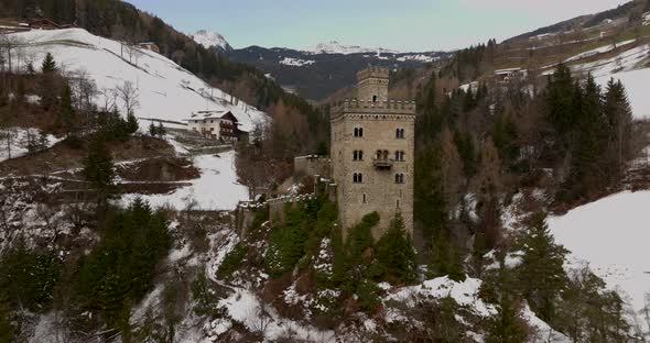 Superb orbit of the amazing Gernstein Castle, it is located over a hill in the Dolomites winter land