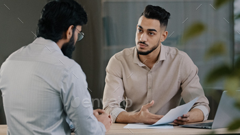 gent lawyer worker consulting unknown male client customer explaining insurance contract benefits negotiating giving business advice at office meeting. High quality photo