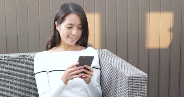 Woman use of cellphone at outdoor coffee shop