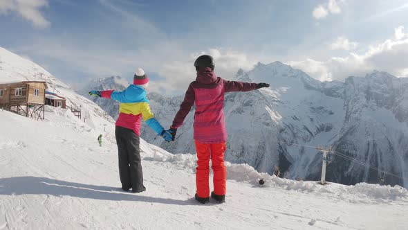 Mother and Daughter Enjoying Journey. Happy Family in Winter Clothing at the Ski Resort, Winter Time