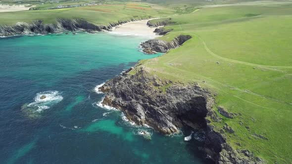 Lush Green Meadow At Kelsey Head With Poly Joke And Crantock Beach In Summer By Calm Blue Sea In New