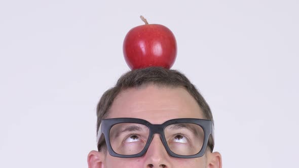 Closeup Head Shot of Nerd Man with Apple on Head