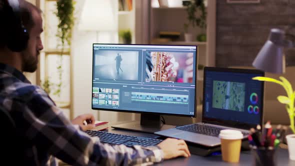 Filmmaker Wearing Headphones and Taking a Sip of Coffee