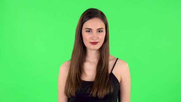 Girl Listens To Information Looking at Camera, Is Shocked and Smile. Green Screen