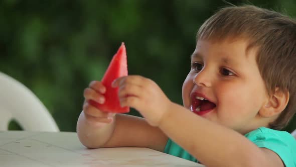 Little Cute Boy Eats Juicy Watermelon with Fun