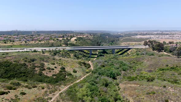 Aerial View of Road Highway Bridge, Viaduct Supports in the Valley Among the Green Hills.