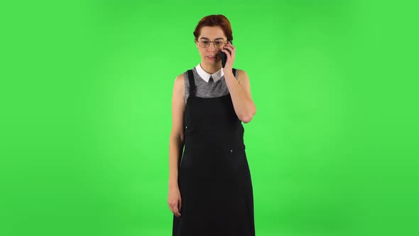 Funny Girl in Round Glasses Is Angrily Talking for Mobile Phone, Green Screen