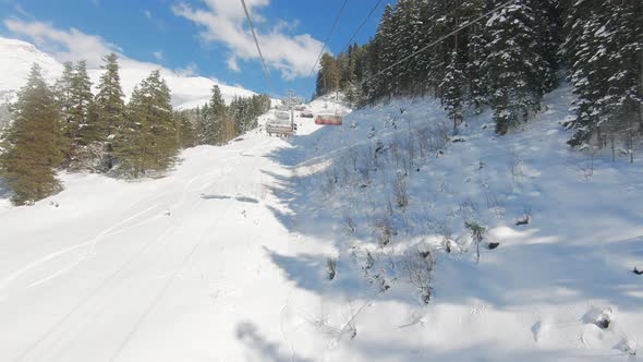 Winter Panorama with Ski Lifts and Snow Covered Mountains on a Sunny Day