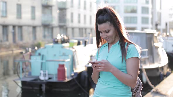 Woman in the city of London holding mobile phone