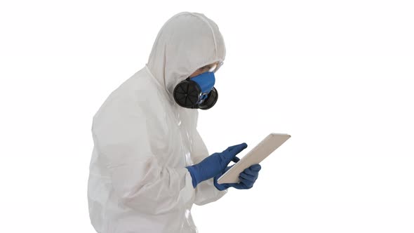 Scientist or Docrot Wearing Biohazard Suits and Protective Masks Using Digital Tablet While Walking